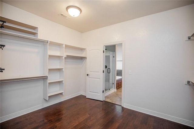 walk in closet with wood-type flooring