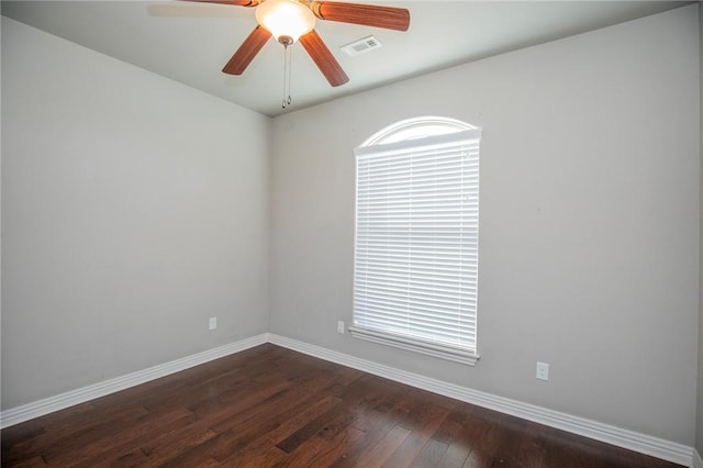 empty room with dark wood-type flooring and ceiling fan