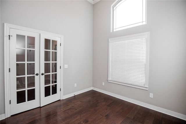 unfurnished room featuring french doors and dark hardwood / wood-style floors