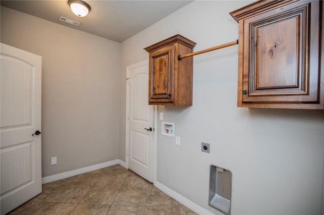 clothes washing area featuring electric dryer hookup, washer hookup, cabinets, and light tile patterned flooring