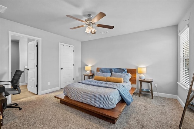 bedroom featuring ceiling fan and light carpet