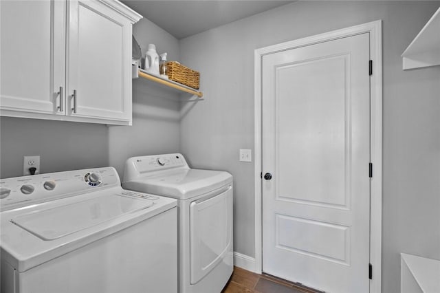 laundry room with cabinets and washer and clothes dryer