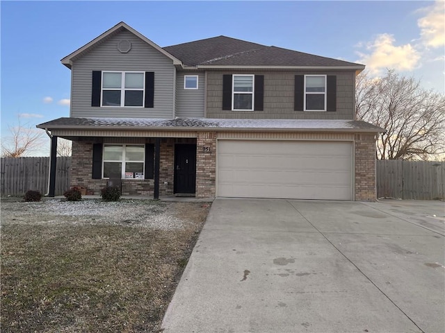 view of property featuring a garage and a porch