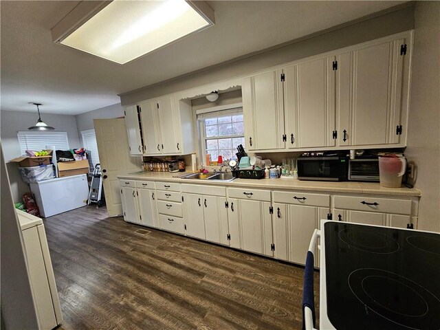 708 N Oak St, Harrison, AR 72601 - kitchen with electric range, white cabinetry, light countertops, dark wood-style floors, and a sink
