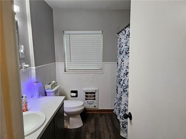 708 N Oak St, Harrison, AR 72601 - full bathroom with heating unit, tile walls, vanity, wood finished floors, and toilet