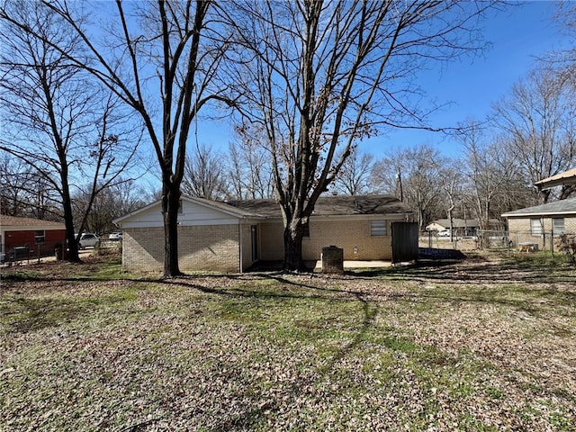 view of side of home with a lawn