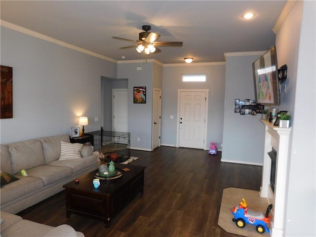 living room featuring ceiling fan, dark wood-type flooring, and ornamental molding