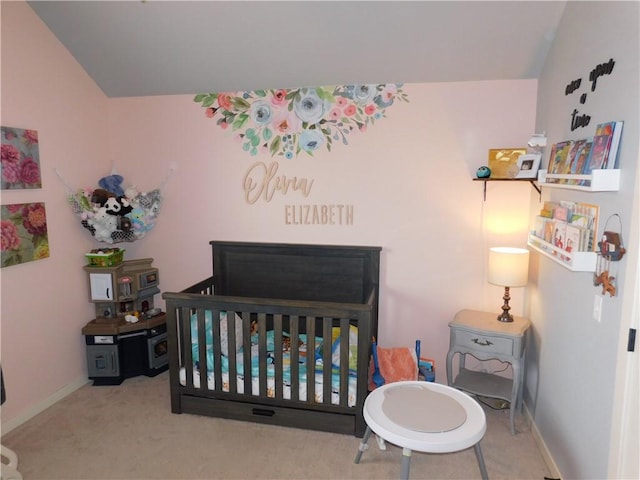 carpeted bedroom featuring a crib