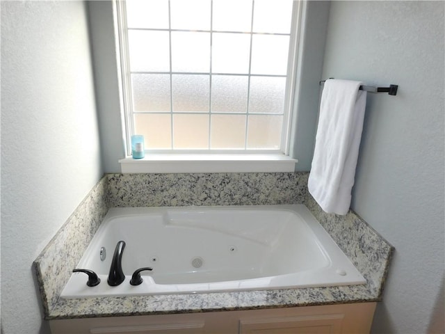 bathroom featuring a tub to relax in