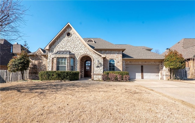 view of front of home with a front lawn and a garage