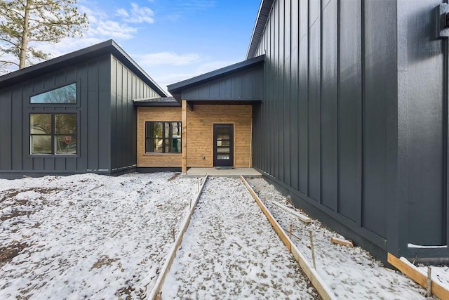 view of snow covered property entrance