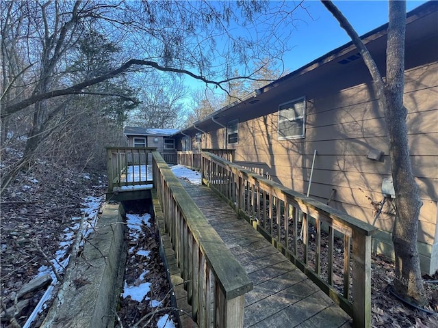 snow covered property featuring a deck