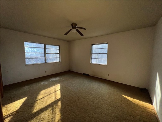 unfurnished room featuring plenty of natural light and ceiling fan