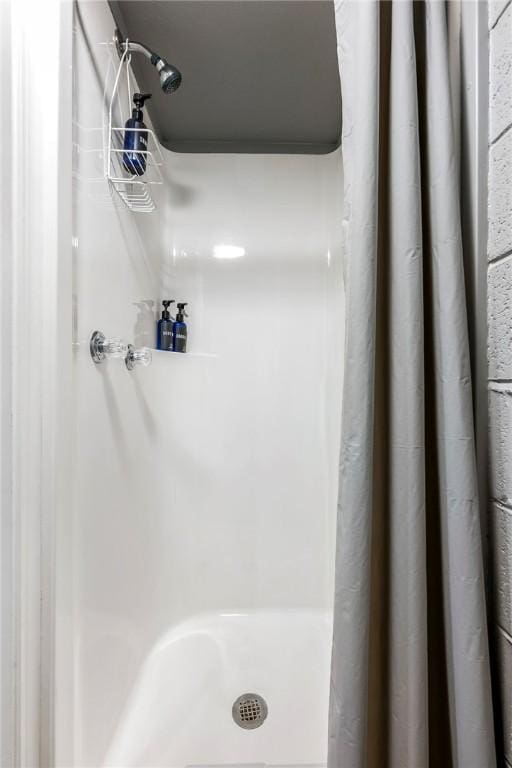 full bath featuring a shower stall