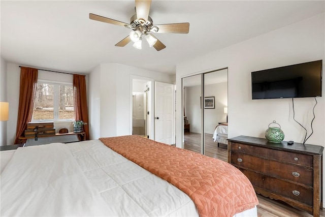 bedroom featuring light wood-style floors, a closet, and ceiling fan