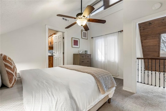 carpeted bedroom with a ceiling fan, visible vents, and vaulted ceiling