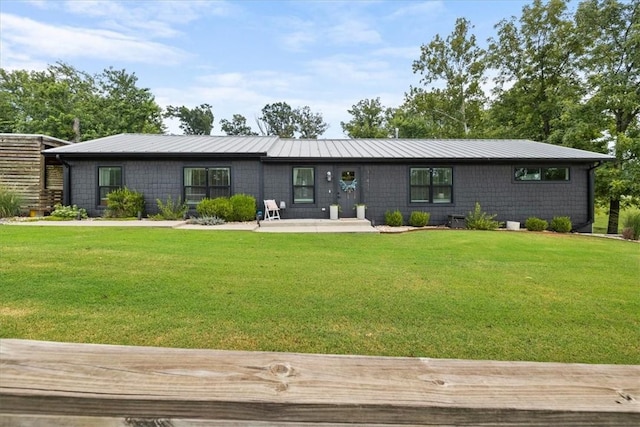 mid-century inspired home with metal roof and a front lawn