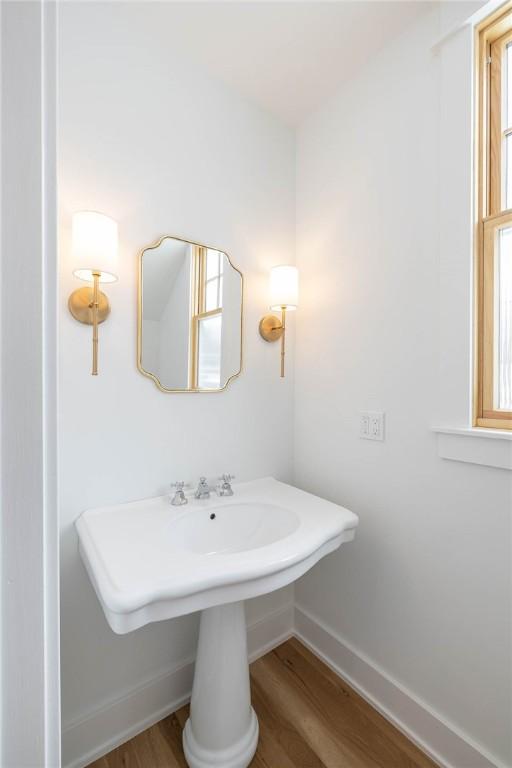 bathroom with baseboards and wood finished floors