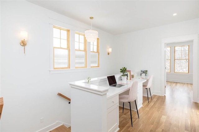 dining room with baseboards and light wood-style flooring