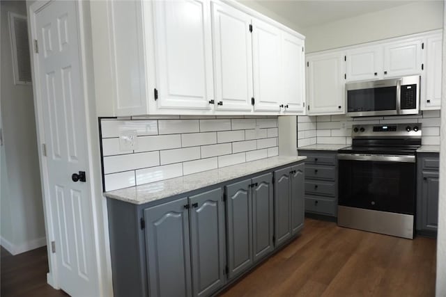 kitchen featuring white cabinetry, dark wood-type flooring, and stainless steel appliances