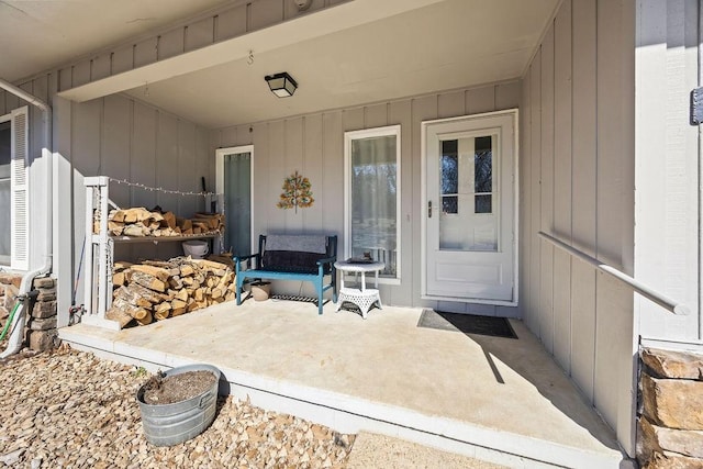 view of exterior entry with a patio area