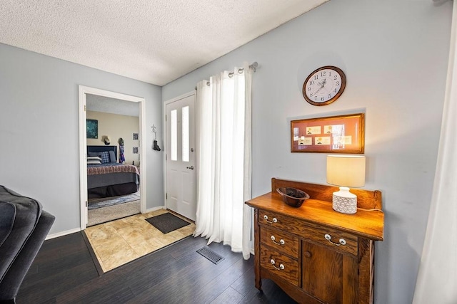 foyer featuring a textured ceiling and hardwood / wood-style floors