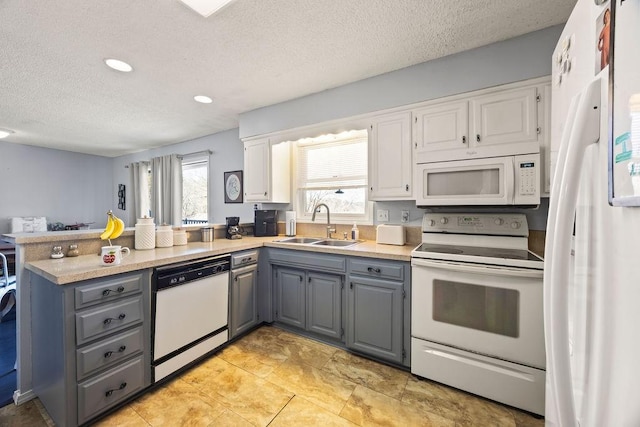 kitchen featuring white appliances, sink, gray cabinetry, kitchen peninsula, and white cabinets