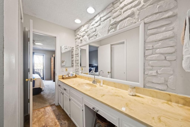 bathroom with vanity and a textured ceiling