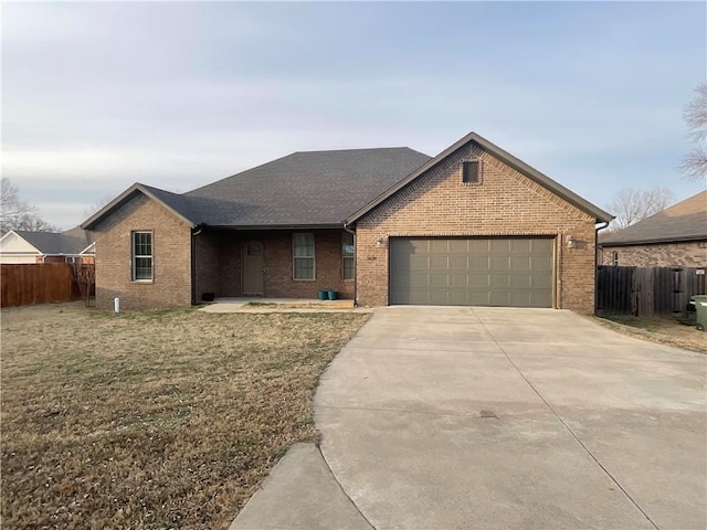 ranch-style house with a front lawn and a garage