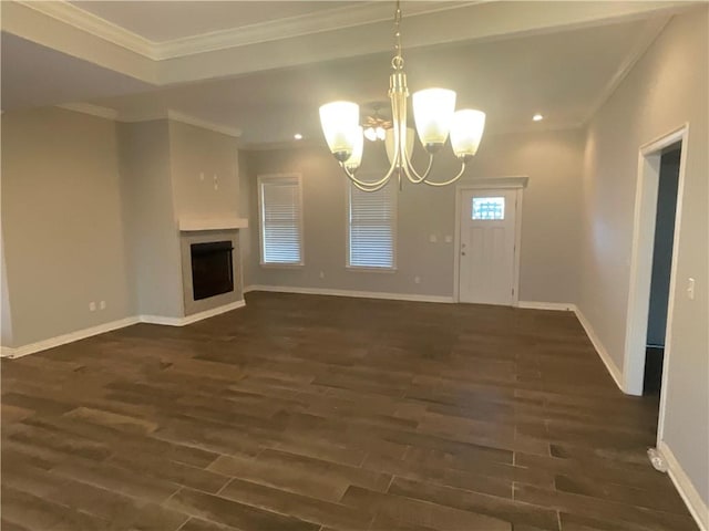 unfurnished living room with ornamental molding, a chandelier, and dark hardwood / wood-style floors