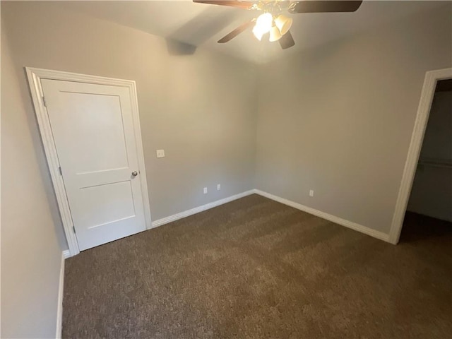 unfurnished bedroom featuring dark colored carpet and ceiling fan