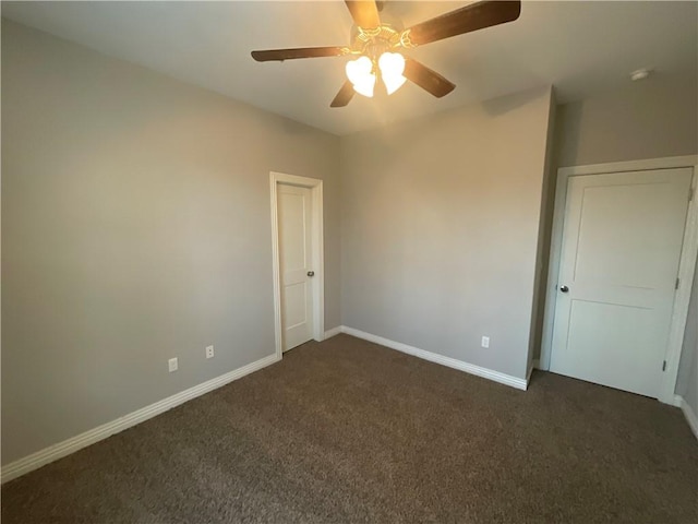 unfurnished bedroom featuring ceiling fan and dark colored carpet