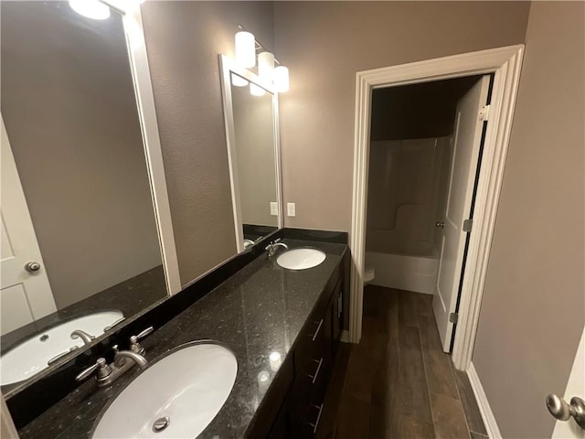 bathroom featuring vanity, walk in shower, toilet, and hardwood / wood-style floors