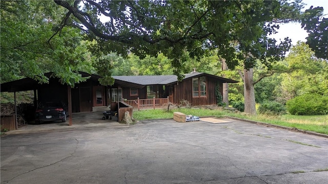 view of front of property with aphalt driveway and a carport