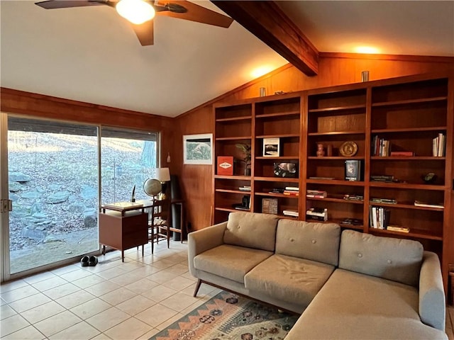 living area with vaulted ceiling with beams, ceiling fan, light tile patterned floors, and wood walls