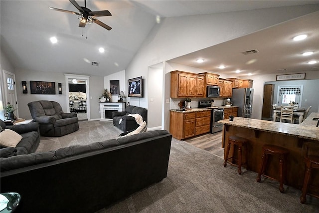 carpeted living room featuring high vaulted ceiling and ceiling fan