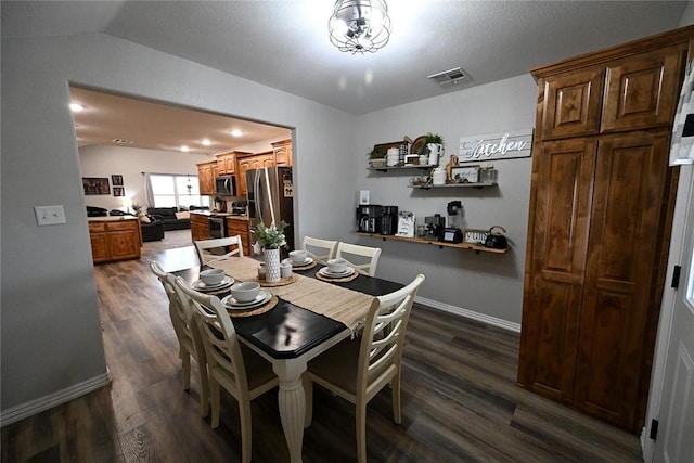 dining room with lofted ceiling and dark hardwood / wood-style flooring