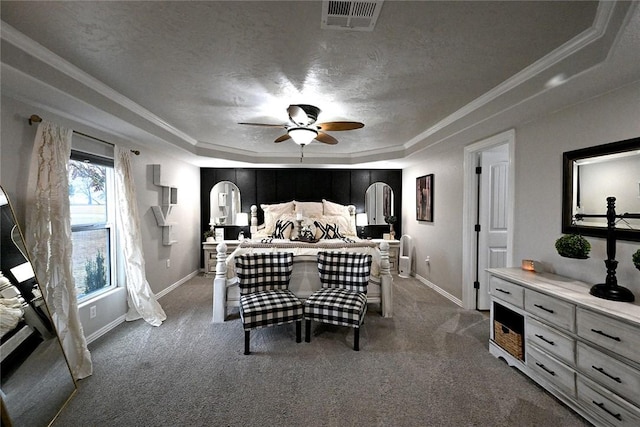 bedroom with a raised ceiling, carpet flooring, a textured ceiling, and ornamental molding