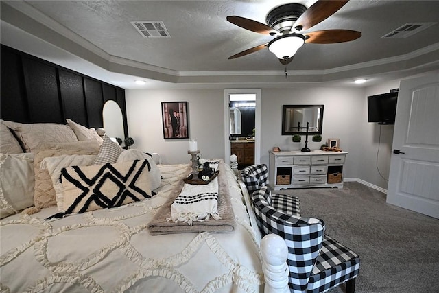 bedroom with carpet floors, a tray ceiling, ceiling fan, a textured ceiling, and crown molding