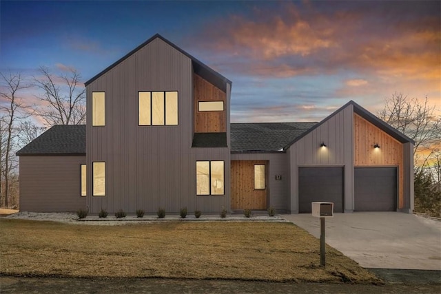 modern home with a garage and a yard