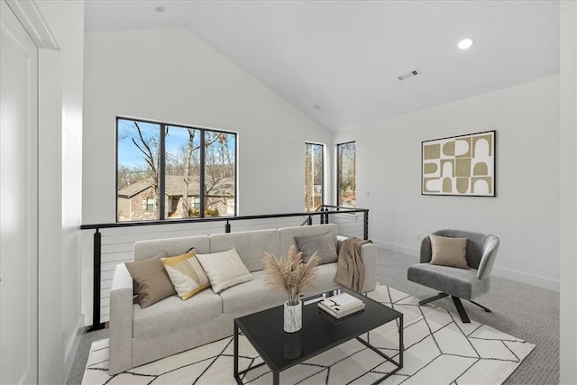 living room with high vaulted ceiling and light carpet