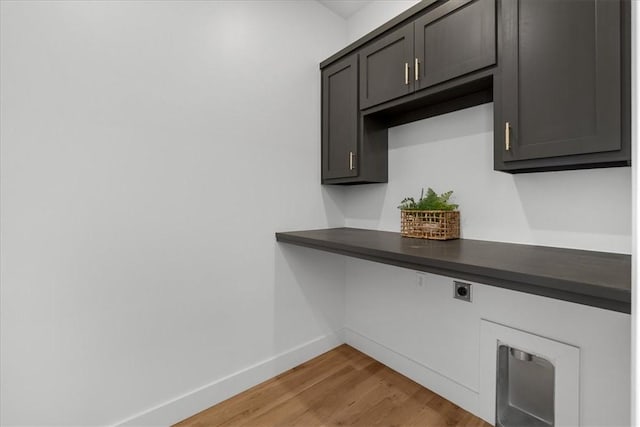 interior space featuring light hardwood / wood-style floors, cabinets, and electric dryer hookup