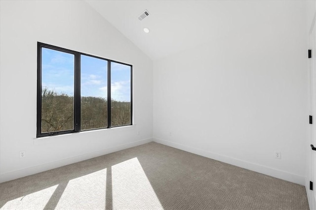 carpeted empty room featuring high vaulted ceiling