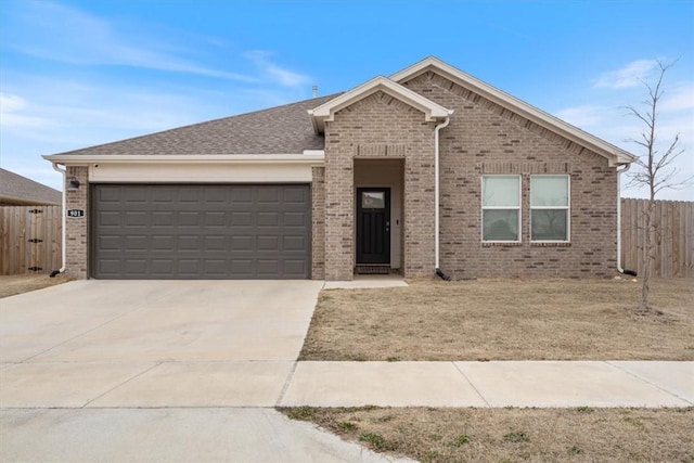 ranch-style house with an attached garage, driveway, and fence