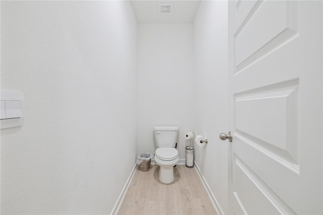 bathroom featuring toilet and hardwood / wood-style floors