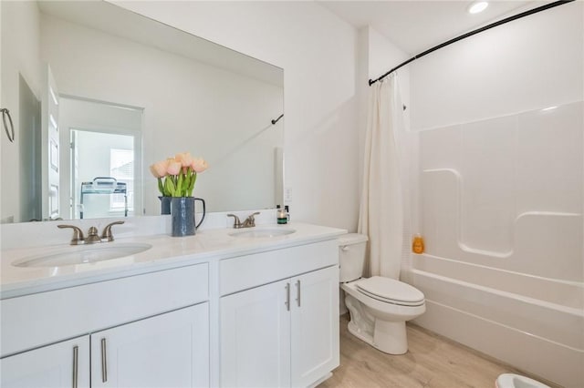 full bathroom with shower / tub combo with curtain, vanity, toilet, and hardwood / wood-style flooring