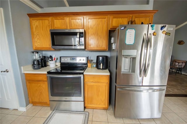 9998 Farm Rd Unit 2240, Washburn, MO 65772 - kitchen featuring brown cabinets, stainless steel appliances, light tile patterned flooring, light countertops, and baseboards