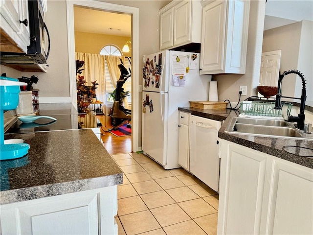 kitchen featuring light tile patterned flooring, sink, white appliances, and white cabinetry