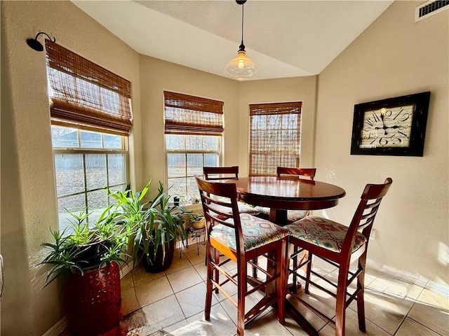 dining space featuring lofted ceiling