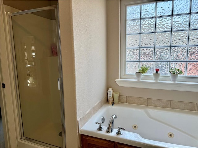 bathroom featuring independent shower and bath